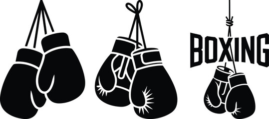 Three pairs of black boxing gloves hanging with a boxing sign