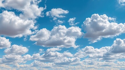 A vast expanse of fluffy cumulus clouds against a vibrant blue sky