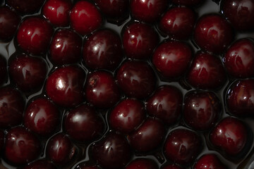 Juicy seasonal black cherries close-up