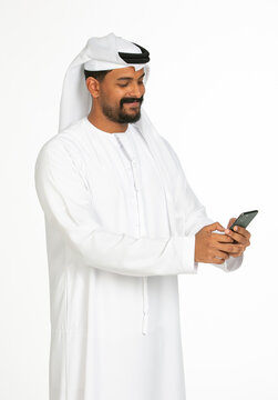 Portrait of an emirati man on a white background using mobile.
