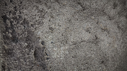 Grungy wall with worn texture, aged cement, and rough cracked surface. Perfect for damaged architecture background.