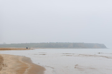 the coast of the Black sea in the north of istanbul and a jeep at the distance on a foggy day