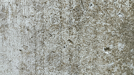 Urban concrete wall with aging signs and rough surface. Cracked cement texture great for digital overlays or background visuals.