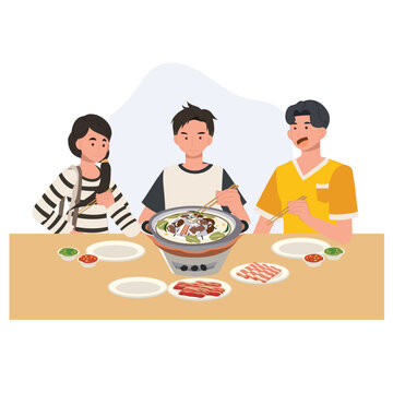 thai barbecue moo krata with friends enjoying grilled pork and vegetables on a tabletop grill at dinner