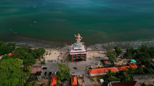 Drone view captures the towering tsunami shelter with the Baruna statue atop, blending practical design for disaster safety with intricate traditional sculpture work.