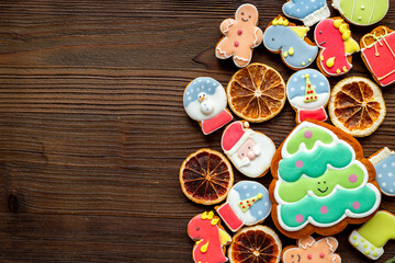 Set of different Christmas and New Year gingerbread cookies on dark wooden background, top view. Festive food concept