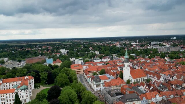 Aerial view of the old town featuring the Celle Castle and the Stadtkirche church with a striking white facade and green spire, Celle, Lower Saxony, Germany.