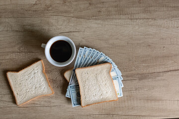 Money sandwich made of dollars and morning coffee