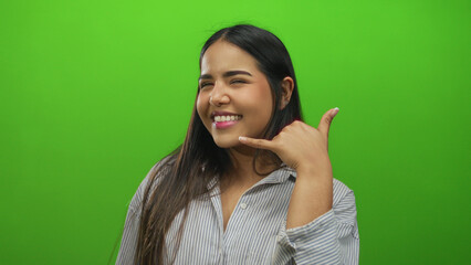 Woman uses hand calling gesture over green to portray young latin hispanic person standing before...