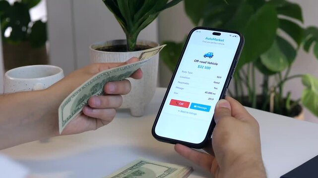 Close-up of a man's hands browsing car listings on a smartphone, then thoughtfully holding cash while considering a purchase. Perfect for automotive ads, financial planning content, or e-commerce