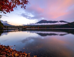 Obraz premium Autumn lake sunrise reflecting mountains