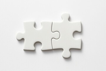 Two interlocking white puzzle pieces creating a connection on a clean white background