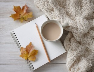 Autumnal workspace with notebook, coffee, and leaves