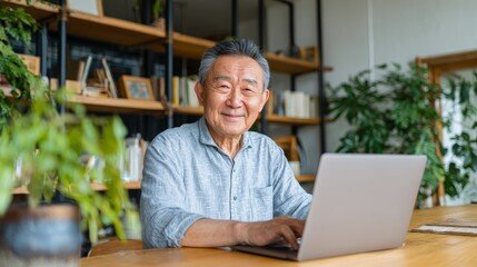 Senior man working on laptop at home office modern design cozy environment relaxed viewpoint