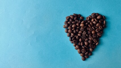 Coffee Beans in Heart Shape on Blue Background