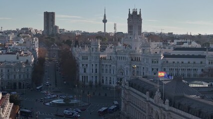 Aerial view of the stunning white Cibeles Palace, with its intricate architecture, and the iconic communications tower, Madrid, Comunidad de Madrid, Spain. - Powered by Adobe