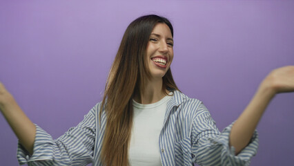 Obraz premium Young hispanic woman smiling and crossing her arms in refusal gesture in purple studio setting; denial.