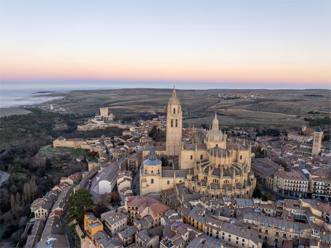 Aerial view of the magnificent Segovia Cathedral and the Alc&Atilde;&iexcl;zar fortress standing proud amidst the ancient cityscape, basking in the soft hues of twilight, Segovia, Castilla y Le&Atilde;&sup3;n, Spain.