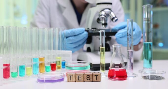 A scientist conducts experiments with colorful liquids and a microscope in a hightech research laboratory