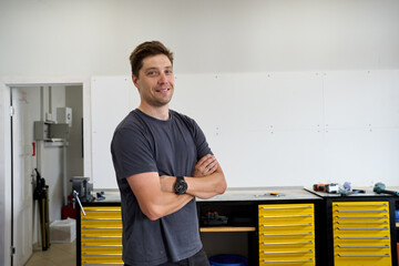 Man in newly renovated cycling repair shop smiling