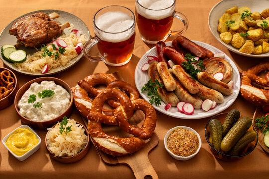 Top view of a German feast with sausages and pretzels