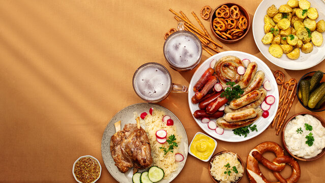 German feast with sausages, pork knuckle, and potato salad
