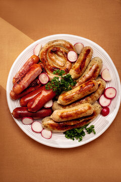 Assorted German sausages with radish and parsley garnish