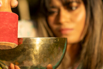 Woman practicing mindfulness with a singing bowl