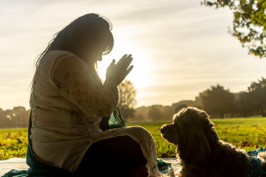 Indian woman practicing meditation in a serene park