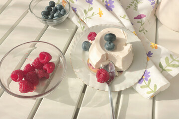 Ricotta cheese dessert with berries. Table setting. Raspberries and blueberries. Healthy eating and vitamins. Environmentally friendly products. Mediterranean diet.