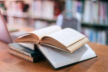 Books in the library and a laptop represent the concept of basic education.

