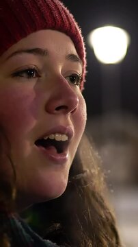 Winters chill transforms breath into visible vapor as a person joyfully sings a Christmas carol, capturing the festive holiday spirit.