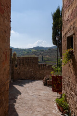 A pretty but deserted alleyway in Montefioralle, Tuscany, Italy, with the countryside of the Val di Greve beyond.