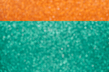Colorful orange and green glitter large bokeh background