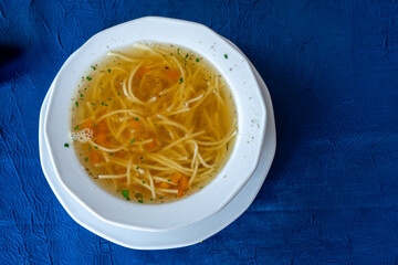 Traditional Polish broth noodle soup (rosół) with carrots