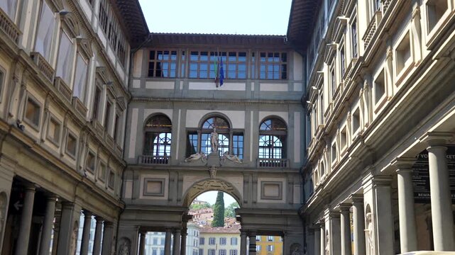 Uffizi Gallery Courtyard with Renaissance Arches and Italian Flag