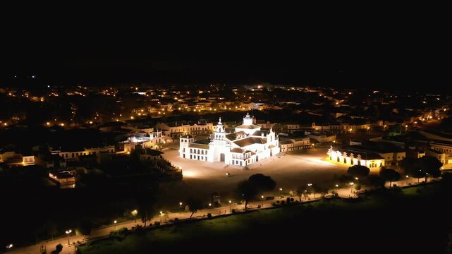 Aerial over the El Rocio Catholic Church. Night as bright lights illuminate the Santuario de Nuestra Se&ntilde;ora del Roc&iacute;o.