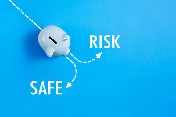 Piggy bank with risk and safe text 