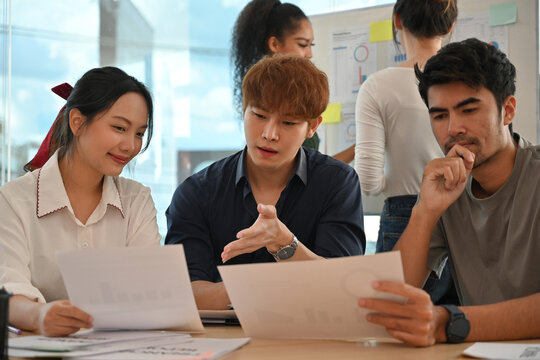 Group of young professionals analyzing business strategies during an engaging team brainstorming session
