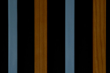 A black and brown striped wooden surface with blue stripes