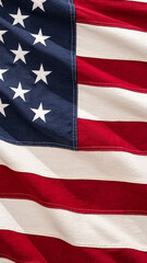 Fototapeta premium An American flag displays vibrant colors and distinct stars as it waves softly in the breeze under bright sunlight, celebrating national identity and unity.