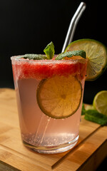 Summer watermelon cocktail with lime, mint and ice, close-up