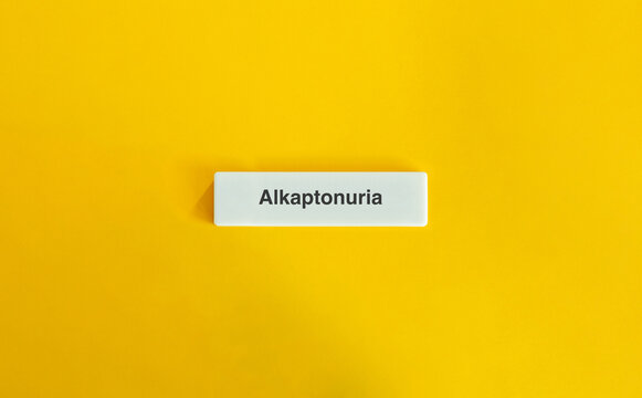 Alkaptonuria Word on Letter Tile with Minimal Yellow Background