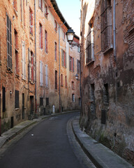 Fototapeta premium Typical narrow street of Toulouse city in the south of France