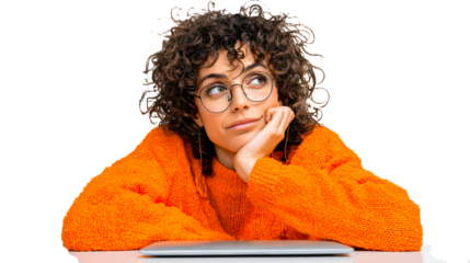 Creative curly haired woman thinking at desk with laptop