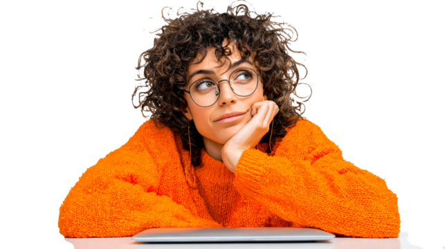 Creative curly haired woman thinking at desk with laptop - Powered by Adobe