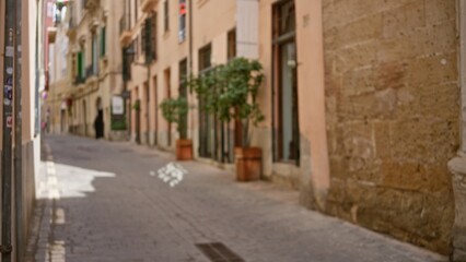 Blurred mediterranean street view with defocused background highlighting charming old town architecture and bokeh effect in the warm afternoon light.