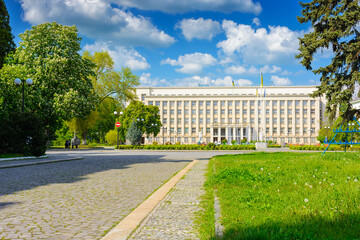 Fototapeta premium uzhhorod, ukraine - 06 may, 2017: government building of zakarpattia state administration. czechoslovakia architecture and cobblestone street of transcarpathia capital in evening light. narodna square