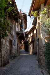 Charming narrow street lined with rustic houses in a historical village during the tranquil morning light