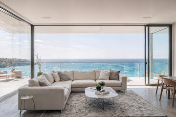 Modern Luxury Living Room with White Leather Sectional Sofa, Floor-to-Ceiling Windows, and Panoramic Ocean View
